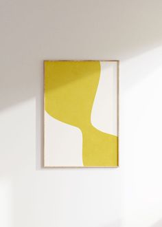 a yellow and white painting hanging on the wall