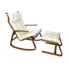 a wooden rocking chair and ottoman with white cushions