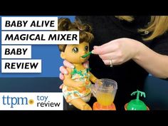 a baby alive doll is next to a cup with liquid in it and the words, baby alive musical mixer baby review