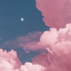 the moon is shining in the sky above some clouds and pinkish hues on a clear day