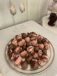 chocolate covered strawberries are arranged on a silver platter