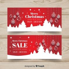 two christmas sale banners on wooden background with snowflakes and baubles in red