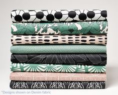 a stack of different colored and patterned fabrics on top of each other in various patterns