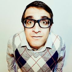 a man with glasses making a funny face