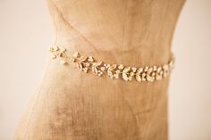 "ANIA SASH- GOLD DESCRIPTION Gold Boho Vine Shaped Golden Shadow Swarovski Crystal & Dainty Pearl Wire Wrapped Sash/ Belt by Camilla Christine Bridal Accessories & Wedding Jewelry - Made of Gold Plated Brass - Golden Shadow & Clear Swarovski Crystals & Cream Colored 4mm Swarovski Pearls - Measures 14\" long by 1\" wide - Ivory Satin 3/8\" wide Ribbon Tie - Ships in 3-5 Business Days - Also Available in Silver (See Separate Listing) ---------------------POLICIES------------------ Golden Shadow, Wedding Belt, Wedding Sash Belt, Wedding Wraps, Wedding Belts, Sash Belts, Sash Belt, Swarovski Pearls, Ribbon Tie