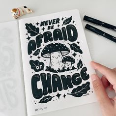 someone is holding up a book with the words never be afraid of change on it