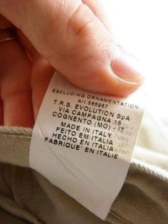 a person is holding onto a label that says