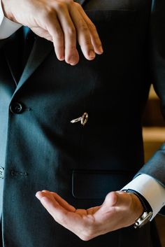 a man in a suit is holding out his hand