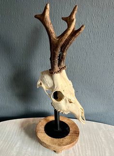 "Unleash the wild charm of nature in your living space with our unique deer skull mounted on a decorative base crafted from repurposed tool parts and wood. Each skull tells a story of the forest, adding a rustic allure to any room. Embrace the fusion of urban and wilderness as the sleek and playful lines of the machine parts perfectly complement the rugged elegance of the deer skull. This one-of-a-kind piece ignites conversation and captivates attention, serving as a bold statement of your adven Deer Skull Mount, Machine Parts, Deer Skulls, Knick Knacks, Collectible Figurines, Deer, Tools, Interior Decorating, Figurines