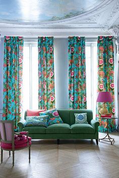 a living room filled with furniture and colorful curtains