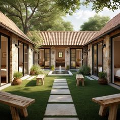 a courtyard with benches and tables in the grass