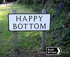 a sign that says happy bottomom on it in front of some grass and bushes