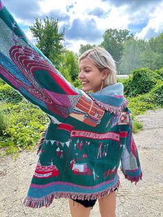 Introducing my latest creation! Upcycled a beautiful vintage county fair themed fringe blanket into this cozy, one of a kind blanket coat! Perfect statement piece for breezy seaside mornings, late nights at festivals, dinner dates, or lounging around the house. Sure to turn heads wherever you may wander! Measurements: Length: 29" Chest: 48" Shoulder to wrist: 22" Unisex design. Model is 5'10 for reference. 100% cotton. Durable, comfortable, sustainable. This statement jacket was made with all of my heart, for any human, anywhere, that may be attracted to its vibe! My intention is that the piece will amplify the divine nature of your inner being. ✨🌙 Turn Blanket Into Jacket, Jacket Made From Blanket, Woven Blanket Jacket Diy, Folk Style Patchwork Outerwear For Festivals, Upcycled Wool Blanket Coat, Blanket Cardigan, Blanket Jacket, Statement Jacket, Blanket Coat