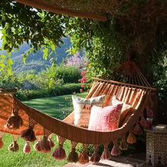 a hammock hanging from a tree in a yard with the words happy birthday on it