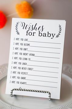 a wish for baby card sitting on top of a plate