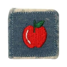 a red apple embroidered on the back of a blue jeanette jeans pocket with a green leaf