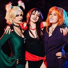 three women dressed in costumes posing for the camera