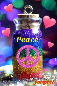 a jar filled with lots of glitter next to butterflies and the words peace on it