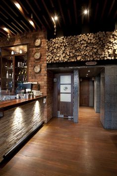 there is a bar with wood stacked on the wall