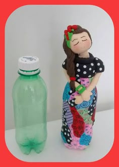 a plastic bottle with a woman in it next to a fake water bottle that is on the table