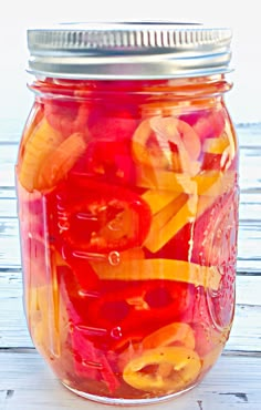 a jar filled with lots of different colored gummy bears in it's lid