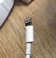 a close up view of an electronic device's usb cable and plugs on a wooden table