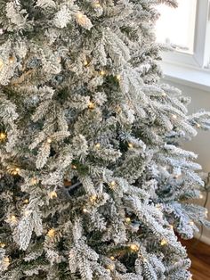 a white christmas tree with lights on it