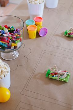 the table is covered with plastic cups and toys