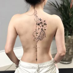 a woman with a lion tattoo on her back