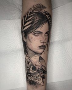 a woman's arm with tattoos on it and an arrow in the middle,