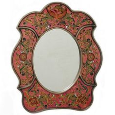 an ornate mirror with red and gold designs on it's sides, set against a white background