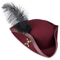 a red hat with a black feather on the side and a gold skull brooch