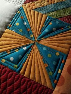 a close up view of a quilted piece of cloth with circles and dots on it