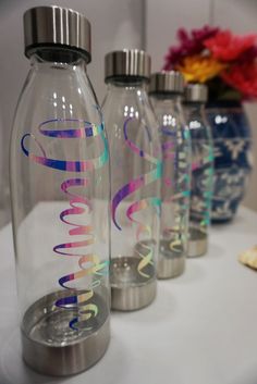 three water bottles with the word love on them are lined up next to each other