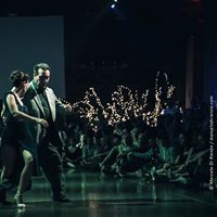 two people dancing on a dance floor in front of an audience