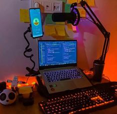 a laptop computer sitting on top of a wooden desk next to a mouse and keyboard