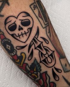 a man with a skull and cross tattoo on his arm