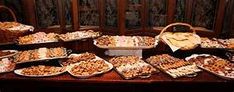 a table topped with lots of trays filled with different types of desserts and pastries