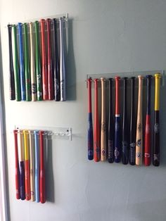 there are many baseball bats hanging on the wall