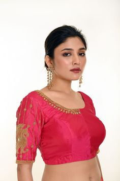 Introducing the Pink Aari Work Bridal Blouse in Pure Silk—a timeless blend of elegance and tradition. Crafted from luxurious pure silk, this stunning bridal blouse features a graceful U-neckline and elegant elbow-length sleeves. The intricate Aari work motifs delicately adorn the blouse, adding a rich and sophisticated touch to your bridal ensemble. Perfect for brides who seek a classic yet refined look, this blouse beautifully complements any saree or lehenga, making it an ideal choice for your special day. Tissue Silk Blouse For Wedding, Elegant Tissue Silk Blouse For Navratri, Tissue Silk Blouse For Reception During Diwali, Tissue Silk Blouse For Reception And Diwali, Tissue Silk Blouse With Cutdana For Receptions, Tissue Silk Cutdana Blouse For Receptions, Cutdana Tissue Silk Blouse For Receptions, Blouse With Pallu For Reception In Traditional Drape, Elegant Art Silk Blouse For Reception