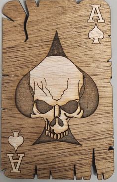 a wooden playing card with a skull on it