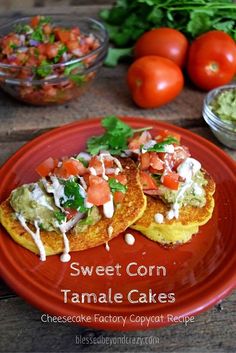 sweet corn tamale cakes on a red plate with tomatoes and cilantro in the background