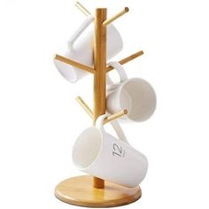 there is a wooden stand with cups and spoons attached to the top of it