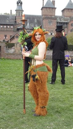 a woman dressed in costume holding a stick