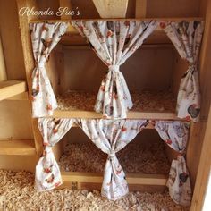 a wooden shelf with curtains on top of it