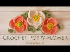 crochet poppy flower applique on wood background