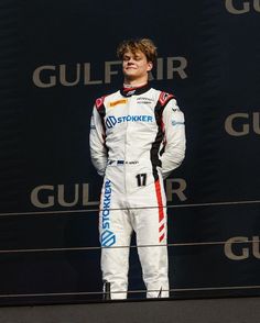 a young man standing on top of a podium