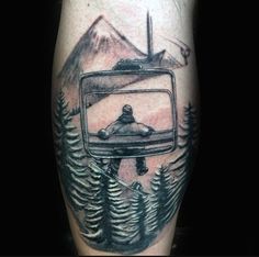 a man's leg with a tv and trees tattoo on the side of his arm