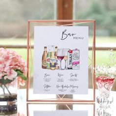 a menu with wine glasses and flowers on a table