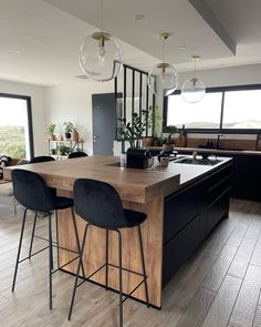 a kitchen island with two bar stools next to it